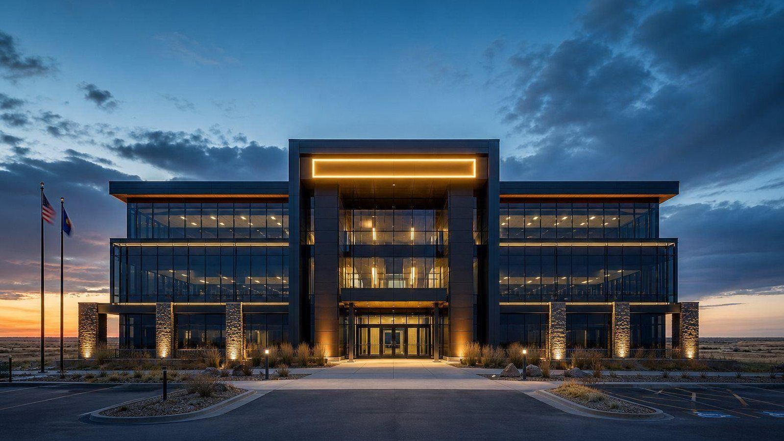 CorEnergy headquarters building at dusk with flags and warm lighting