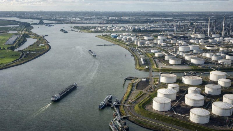 Aerial view of a river port with tank farms and barges in the Amsterdam-Rotterdam-Antwerp region